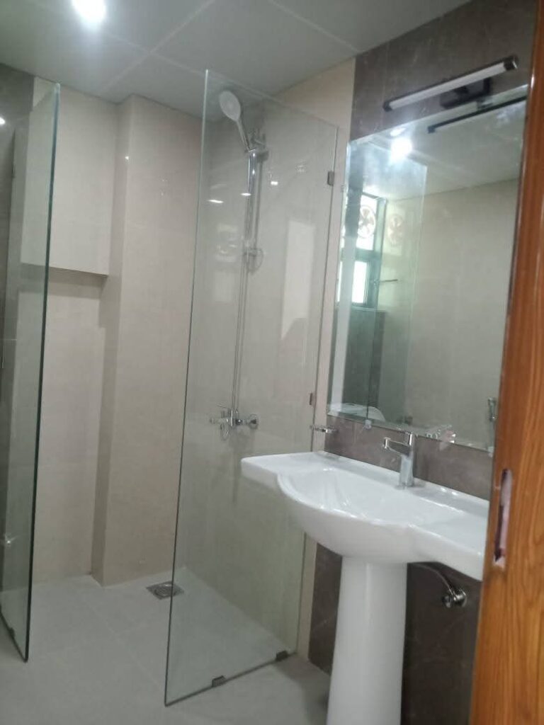 Bathroom with glass shower in Askari 12 Lahore apartment
