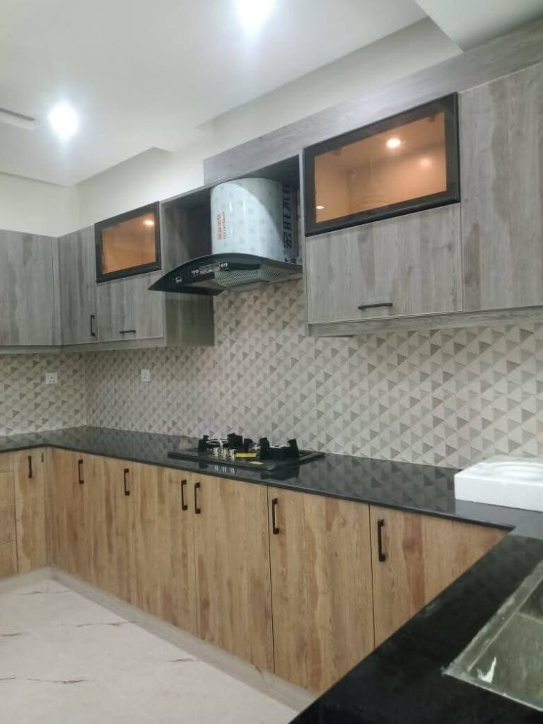 Kitchen with hob and hood in Askari 12 Lahore apartment
